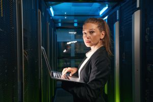 Determined woman with laptop working with servers in data center ~ SilverState Web Design