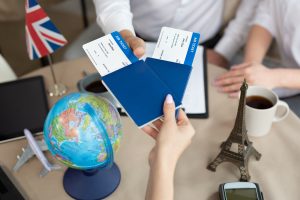 Close-up of passports and tickets in the hands of a travel agent in the office ~ SilverState Web Design